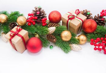 Christmas or New Year background: fur-tree, branches, gifts, colored glass balls, decoration and cones on a white background