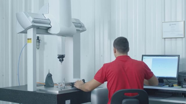 Engineer Sets up and Uses Coordinate Measuring Machine (CMM). Shot on RED Cinema Camera in 4K (UHD)