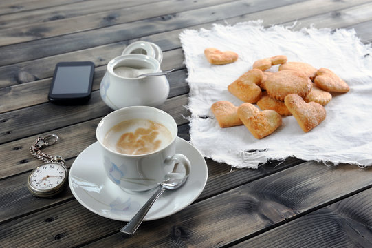 Foods of the Italian breakfast with coffee milk and biscuits on an old wooden table