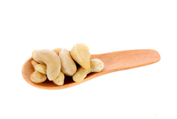 Cashew nuts in spoon isolated on white background