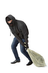 Thief in gloves drags bag