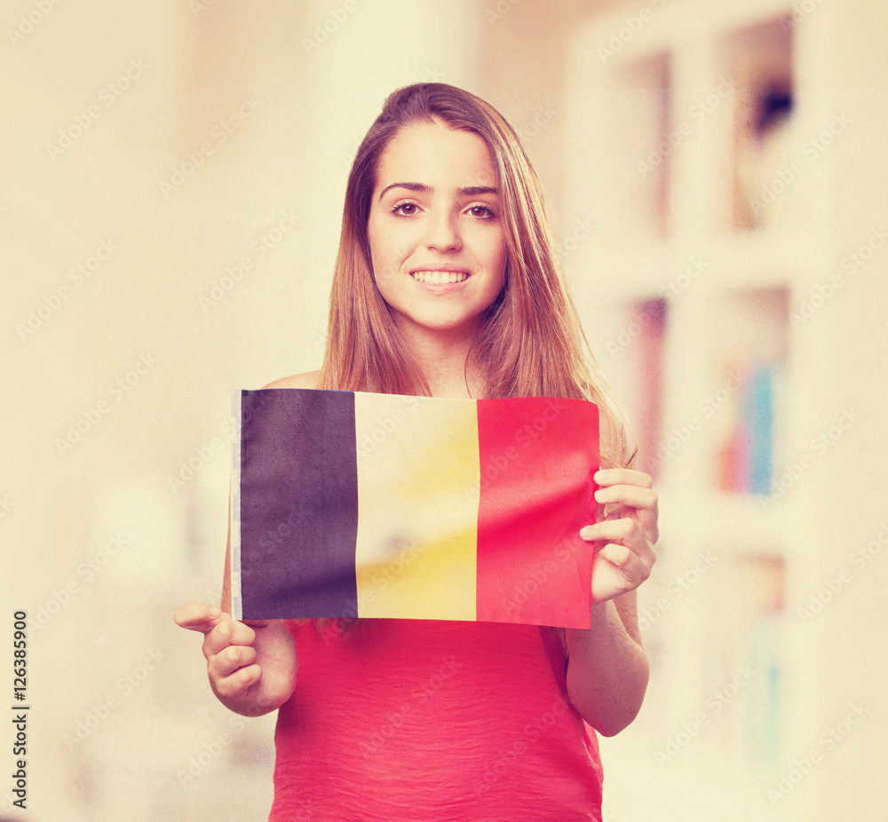 Wall mural young woman holding a belgium flag on white