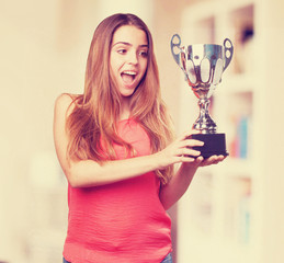 young woman holding a trophy on a white background