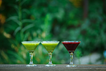 fresh cocktail in martini glass on wooden board. bokeh background.