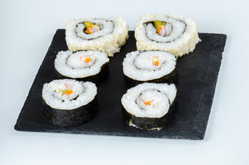 Maki sushi, rolls on slate plate.