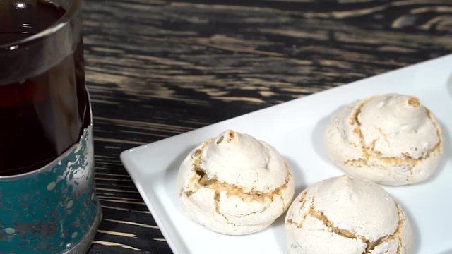 lot of white meringue cakes with tea.