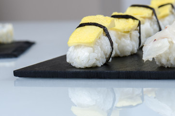 Sushi nigiri set on slate plate.