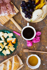 Breakfast on the marble surface. Top view. Ham, cheese, fruit, honey.