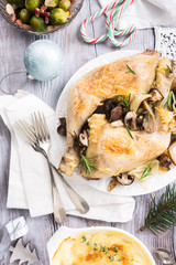 Delicious Christmas themed dinner table with roasted chicken, appetizers and desserts. Top view. Holiday concept.