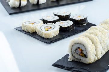 Sushi, california roll with sesame seeds.