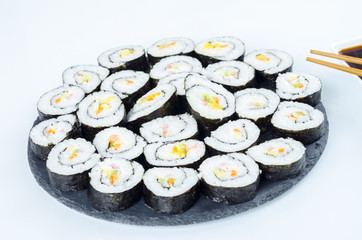 Maki sushi, rolls on slate plate.