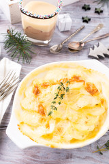 Delicious Christmas themed dinner table with potato gratin. Holiday concept.