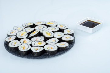 Maki sushi, rolls on slate plate.
