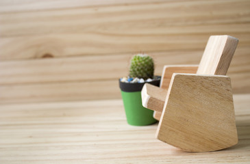 Cactus and wooden chair Placed on a wooden background