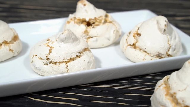 lot of white meringue cakes with coffee