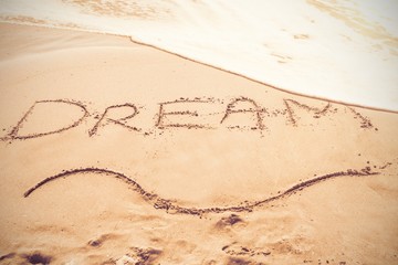Inscription dream on sand
