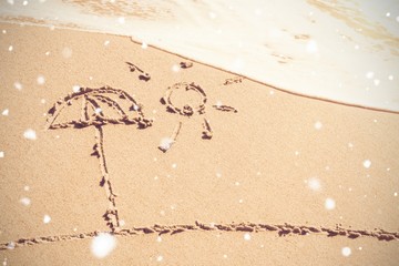 Sun and umbrella drawn on sand