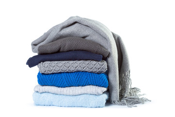 Stack of various sweaters isolated on white background - Powered by Adobe
