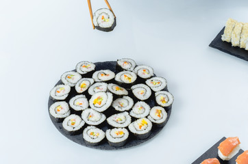 Maki sushi, rolls on slate plate.