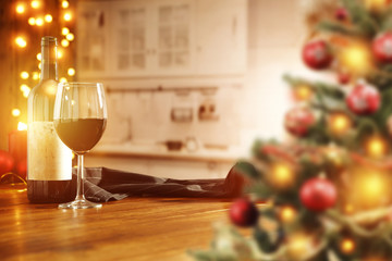 xmas background of kitchen interior and wooden table with wine 