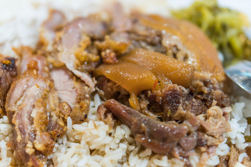 Stewed pork leg on rice with garlic and kale in top view
