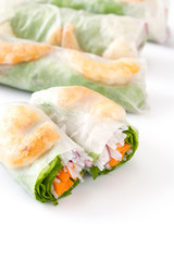 Vietnamese rolls with vegetables, rice noodles and prawns isolated on white background

