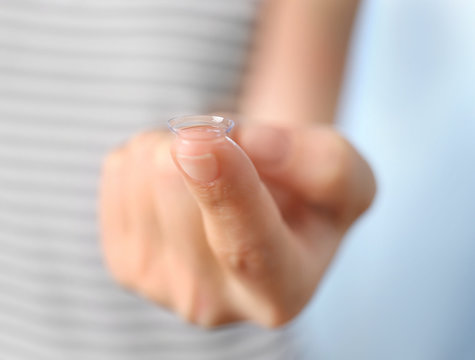 Female hand with contact lens, close up view. Healthy eyes concept