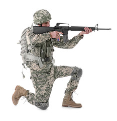Soldier in camouflage taking aim, isolated on white