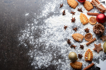 Composition of cookies, flour and natural Christmas decor on grey table