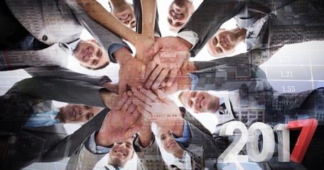Fototapeta na wymiar Composite image of smiling business team standing in circle hand
