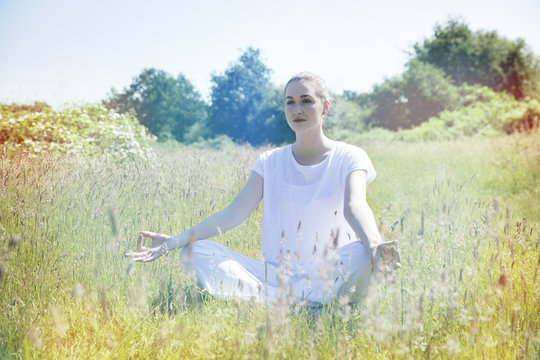 calm young yoga woman meditating for peace and loneliness, toned