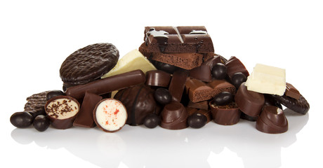 Pile of different chocolate candies isolated on white.