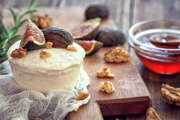 Ricotta with ripe sliced fig fruits, nuts and honey  