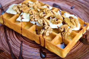 Plate of belgian waffles with cheese and nuts