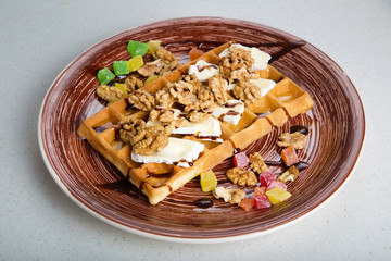 Plate of belgian waffles with cheese and nuts