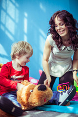 little cute boy and his mother playing together