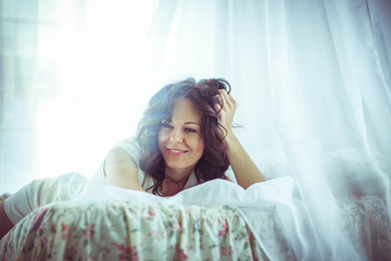 Obraz premium beautiful and gentle young woman lying on bed