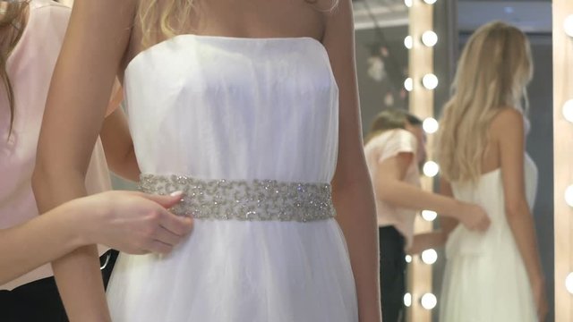 The bride in white wedding gown in wedding salon