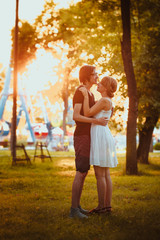 guy and the girl hugging at amusement background