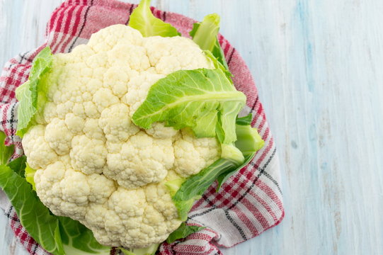 Raw cauliflower on a pile forming background