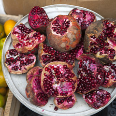 Red juice pomegranate on dark background