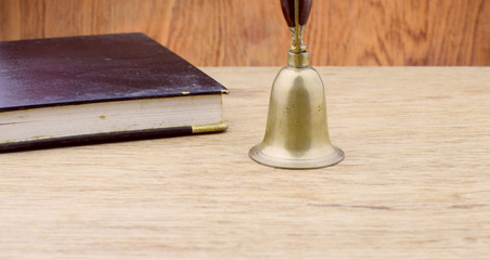Ancient bronze bell on wood background