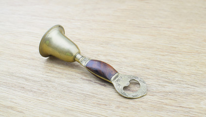 Ancient bronze bell on wood background