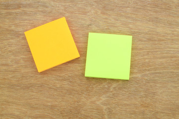 Paper notes (white & yellow) on wood background, selective focus