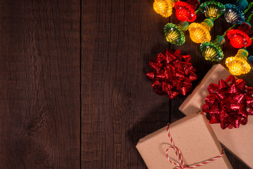 Christmas gifts boxes with garland on a wooden background.