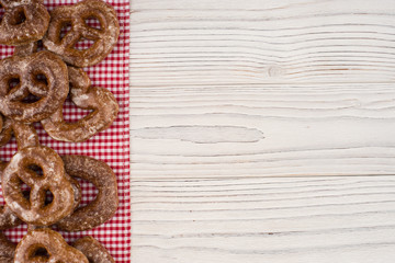 Gingerbread heart cookies on a wooden white background.