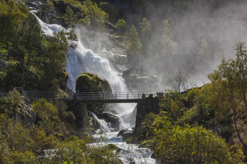 Wooden bridge over the waterfall near Briksdal glacier, Norway