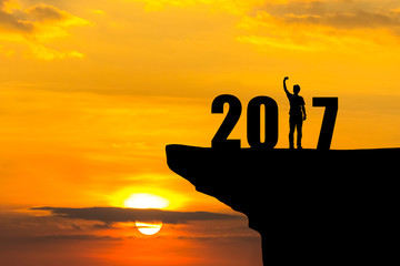 Man in 2017 number of happy new year on cliff