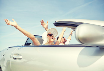 happy man and woman driving in cabriolet car