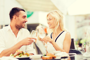 happy couple clinking glasses at restaurant lounge